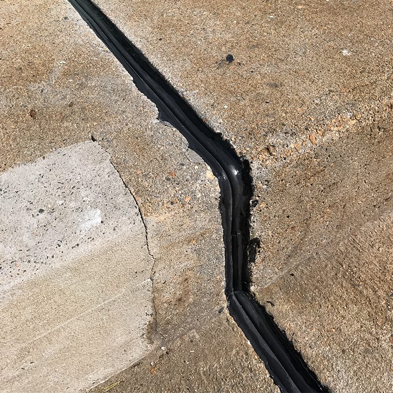 Bridge expansion joint transitions for curbs, sidewalks, parapets