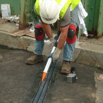 Bridge expansion joint installing the sealant band on BEJS from Sika EMSEAL