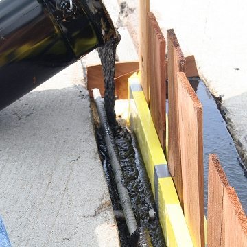 Pouring Emcrete from Emseal to rebuild bridge expansion joint edge