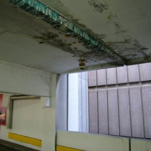 The photo illustrates vividly why expansion joints should be watertight at their top surface. And why gutters can lead to the need for seriously costly repairs. They underscore how gutters conceal leaks, resulting in structural damage that is dangerous and far more costly than the price of an expansion joint that works.