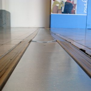 The rolling motion of high-point-load, small wheeled traffic can quickly cup under-designed coverplate systems as well as caused damage to adjacent flooring.