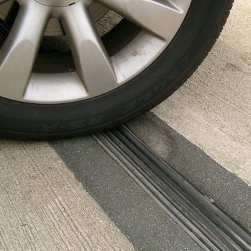 Inspection in June, 2004 of 8-year old THERMAFLEX nosing material at Ronald Reagan International Airport, Middle/North parking garage, shows localized shaving of nosing material to the right of the leading edge of the tire. Caused by errrant snow-plowing the impact scarring is superficial and repairable and the joint remains watertight.