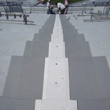 This is a view looking down the completed installation of the SJS SYSTEM in the seating bowl. The sandblasted coverplates are skid resistant and feature a long chamfer on its edges to facilitate pedestrian traffic.