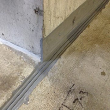 Deterioration of the base of the shear walls required repair using steel plates. The DSM SYSTEM installed as effectively against the steel on one side of the joint as to the concrete on the other.