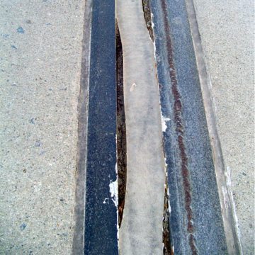 A test joint using another manufacturer’s wax-compound saturated system was installed in the summer of 2005 instead. Predictably, this material was incapable of moving in extension at low temperatures, and along with the liquid sealant installed over it, failed adhesively in November of its first winter as the joints began to open up.