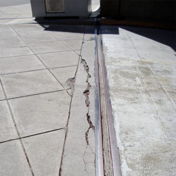 Strip seals, compression seals, self-centering bar-and-gutter systems, are not watertight, are prone to failure, and don’t look that great either. Technology has evolved beyond these systems.
