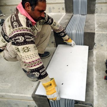 Cover plates designated for each location are lowered into place.