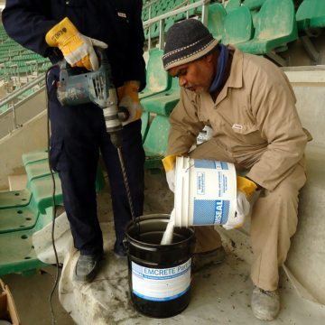 EMCRETE sand and fiber aggregate added to resin and mixed.