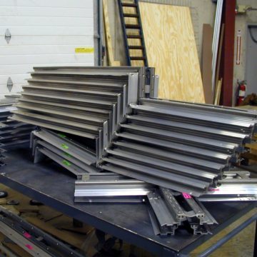 Plaza Expansion Joints: Factory-fabricated crosses, tees, upturns, and curbs in metal components of MIGUTAN ready to ship from EMSEAL plant.