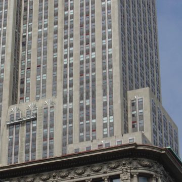 Swing stages look tiny against the massive facade of the Empire State Building as crews work to reseal the 6,514 window perimeters using EMSEAL’s BACKERSEAL behind silicone liquid sealant.