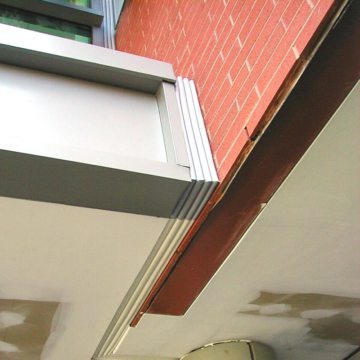 Color switching with Colorseal makes tidy work of matching a transition from metal panels to a drywall soffit.