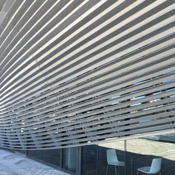 Window wall expansion joints sealed with Seismic Colorseal obscured by Swooping louvers
