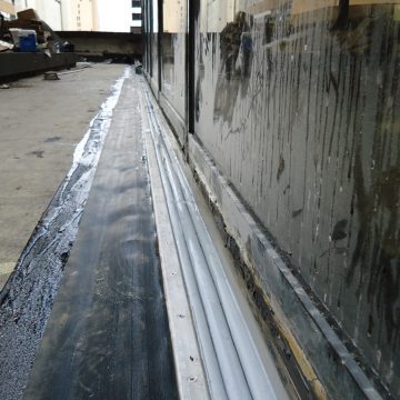 Plaza deck expansion joint sealing: DSM-FP in plaza to wall expansion joint with side sheet 2 Houston Center EMSEAL