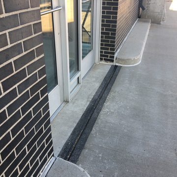 Parking expansion joint at egress doorways EMSEAL Thermaflex