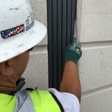 Applying a bead of silicone and tooling with a caulk knife on each edge of the joint. This is to ensure continuity of seal and creates a watertight joint.