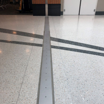 Airport Concourse SJS Floor Expansion Joint Cover Transition to Wall at BNA Nashville International Airport by Sika Emseal