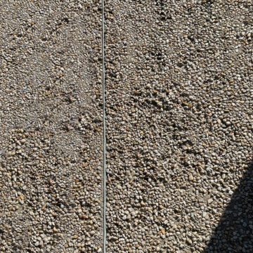 SafeReseal - A Retrofit Joint Sealant System for EIFS, Precast, Concrete, and virtually any substrate that is a safer, grindless, dustless, primerless, tensionless, paintable Joint Sealing System. Here the system is installed in an exposed aggregate concrete Façade.