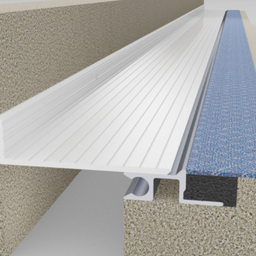 Wabo SeismicFloor FNB seismic interior floor tot wall flush mount expansion joint cover plate system in carpet