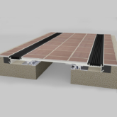 Wabo®SeisMaxPlus NBS interior floor seismic recessed flush expansion joint cover plate system with tile flooring inserted by Sika Emseal