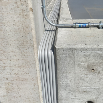 Airport parking deck expansion joint transition at deck to wall interface with Seismic Colorseal and Horizontal Colorseal precompressed foam expansion joint sealants by Sika Emseal