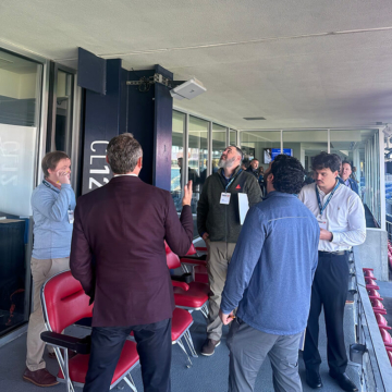 Sika Emseal team observing an overhead watertight stadium expansion joint along a concourse, studying joint performance and building movement.