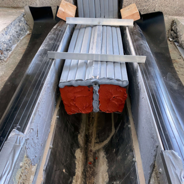 Fire-rated precompressed foam expansion joint system in cross-section during installation at Lumen Field (formerly CenturyLink Stadium), Seattle, WA