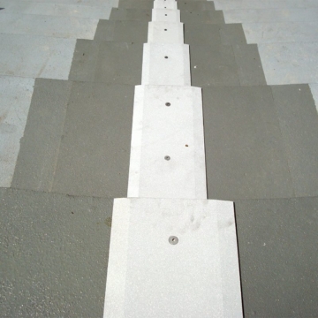 Finished look of SJS seismic expansion joint system in stadium treads and risers, complete with coverplate