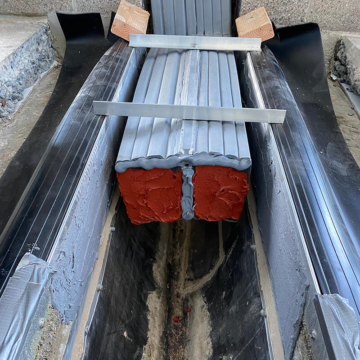 SJS-FR fire-rated expansion joint being installed with red intumescent visible