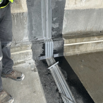 Close-up of the expansion joint installed through a tread-riser vertical transition at Ryan Field, showing the continuous seal as it steps from tread to riser to tread.