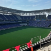 Overview of Ryan Field's seating bowl under construction, with red flags marking expansion joint locations along the upper concourse edge.