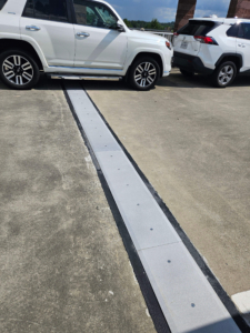 Close-up of finished SJS expansion joint seal with coverplate at the ATL Rental Car Center parking deck.